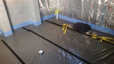 The 150mm insulation over laps the wall insulation and is covered with a plastic sheet before the heating pipe grippers are laid