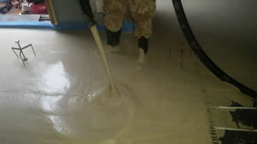 70mm of liquid screed is pumped over the basements underfloor heating system